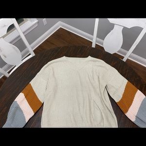 Boutique v-neck sweater. Cream color with color on sleeves.